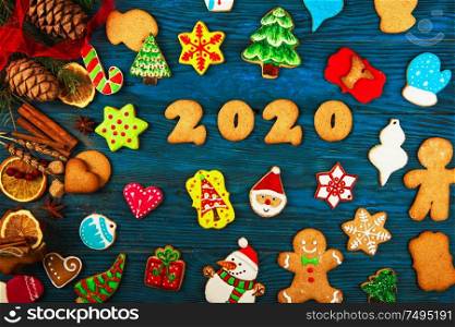 Gingerbreads cookies for new 2020 year holiday on wooden background, xmas theme. Gingerbreads for new 2020 years