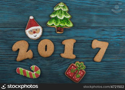 Gingerbreads for new 2017 year holiday on wooden background, xmas theme