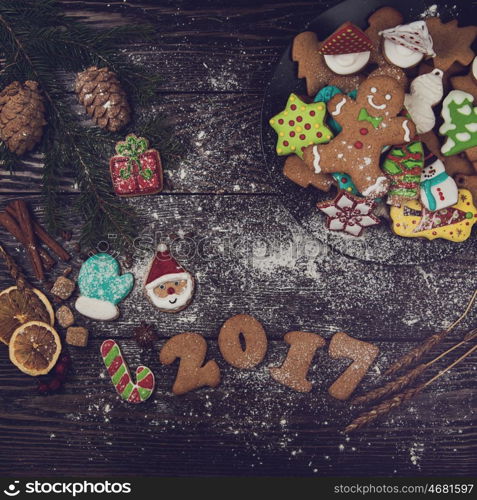 Gingerbreads for new 2017 year on wooden background, xmas theme