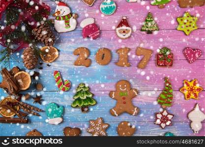 Gingerbreads for new 2017 year on wooden background, xmas theme