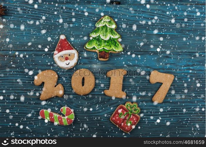 Gingerbreads for new 2017 year on wooden background, xmas theme