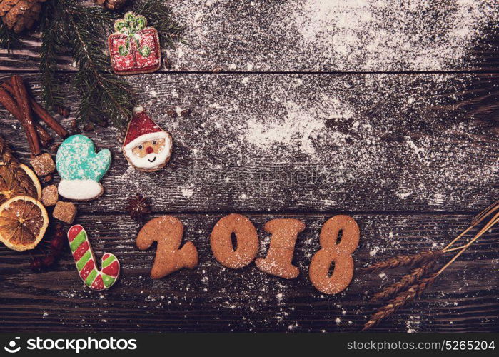 Gingerbreads for new 2018 year on wooden background, xmas theme. Gingerbreads for new 2018 years