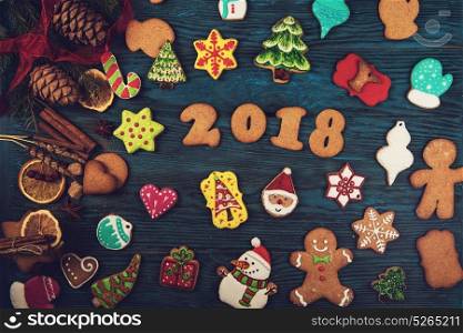 Gingerbreads for new 2018 year on wooden background, xmas theme. Gingerbreads for new 2018 years