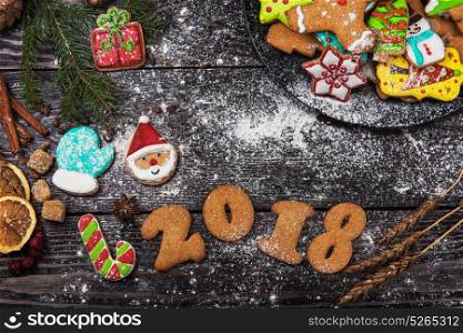 Gingerbreads for new 2018 year on wooden background, xmas theme. Gingerbreads for new 2018 years