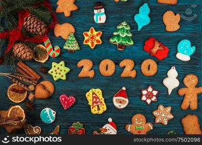 Gingerbreads for new 2020 year holiday on wooden background, xmas theme. Gingerbreads for new 2020 years