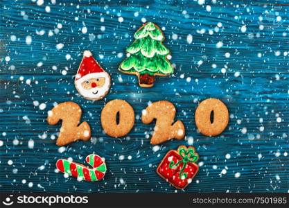 Gingerbreads for new 2020 year on wooden background, xmas theme. Gingerbreads for new 2020 years