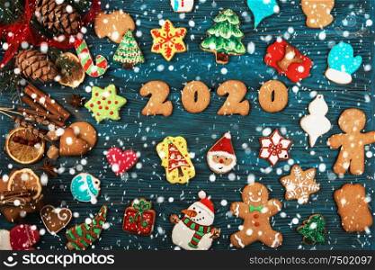 Gingerbreads for new 2020 year on wooden background, xmas theme. Gingerbreads for new 2020 years