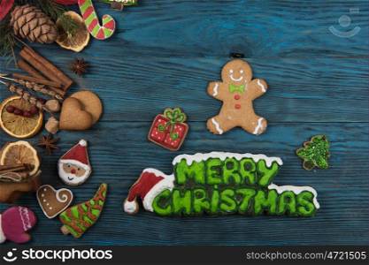 Gingerbreads for new years and christmas. Gingerbreads for new years and christmas on wooden background with space for design