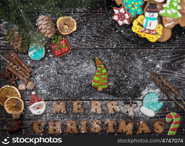 Gingerbreads for new years and christmas on wooden background with space for design. Gingerbreads for new years and christmas