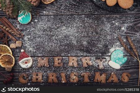 Gingerbreads for new years and christmas on wooden background with space for design. Gingerbreads for new years and christmas