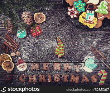 Gingerbreads for new years and christmas on wooden background with space for design. Gingerbreads for new years and christmas