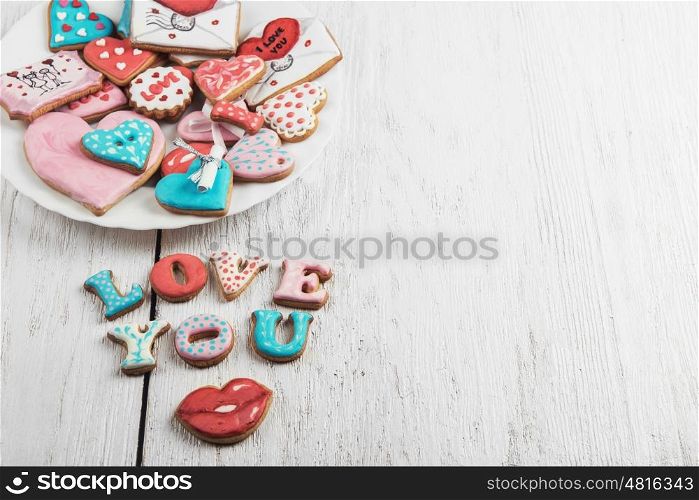 Gingerbreads for Valentines Day. Gingerbreads for Valentines Day at plate on white wooden background