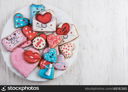 Gingerbreads for Valentines Day. Gingerbreads for Valentines Day at plate on white wooden background