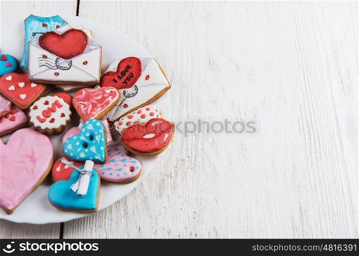 Gingerbreads for Valentines Day. Gingerbreads for Valentines Day at plate on white wooden background