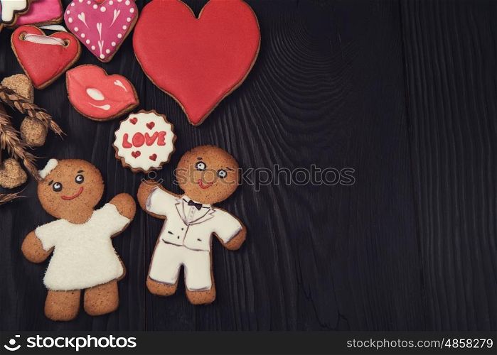 Gingerbreads for Valentines Day. Gingerbreads for Valentines Day on dark wood background