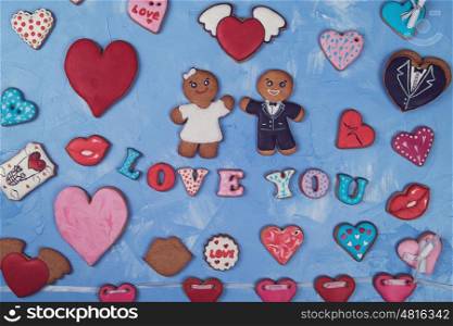 Gingerbreads for Valentines Day. Gingerbreads for Valentines Day or Marriage on blue concrete background