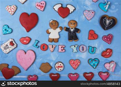 Gingerbreads for Valentines Day. Gingerbreads for Valentines Day or Marriage on blue concrete background