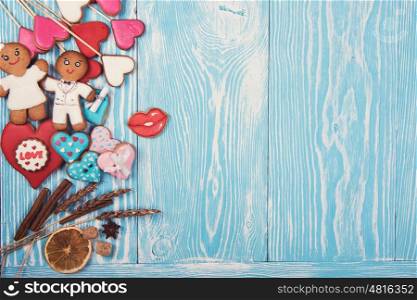 Gingerbreads for Valentines Day. Gingerbreads for Valentines Day or wedding theme on blue wooden background