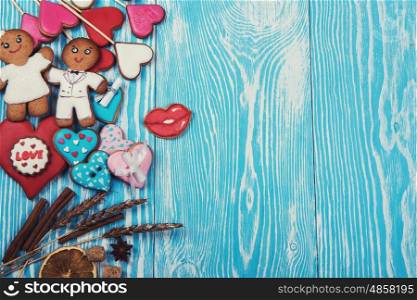 Gingerbreads for Valentines Day. Gingerbreads for Valentines Day or wedding theme on blue wooden background