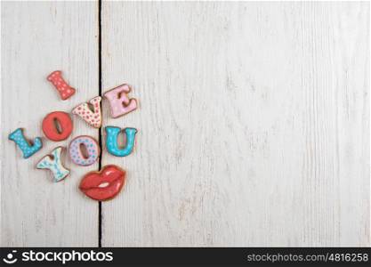 Gingerbreads for Valentines Day in gift box on white wooden background, I love you sign