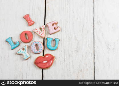 Gingerbreads for Valentines Day in gift box on white wooden background, I love you sign