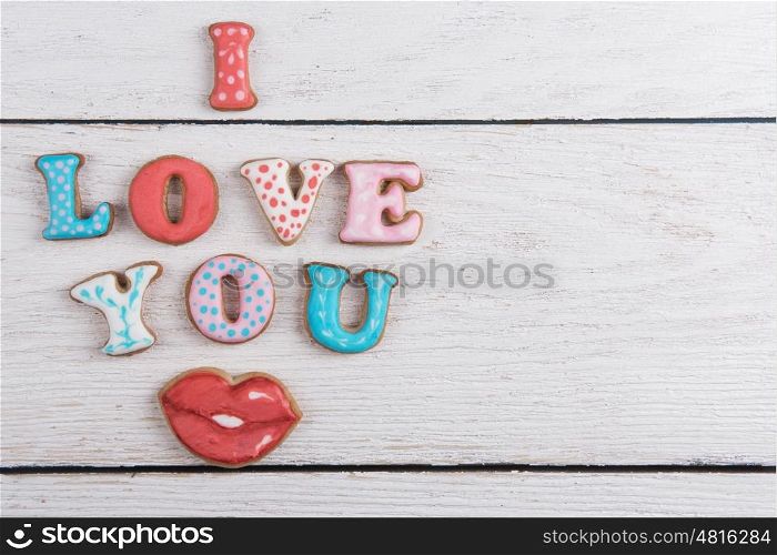 Gingerbreads for Valentines Day in gift box on white wooden background, I love you sign