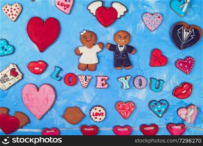 Gingerbreads for Valentines Day or Marriage on blue concrete background. Gingerbreads for Valentines Day