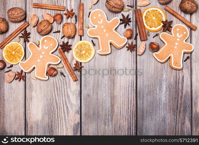 Gingerbreads with spices on the wooden table. Christmas aroma decor