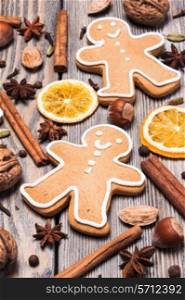 Gingerbreads with spices on the wooden table. Christmas aroma decor
