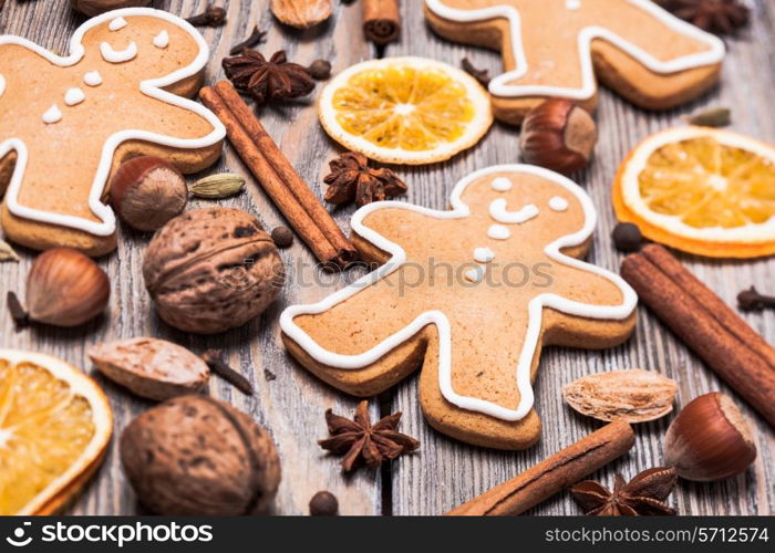 Gingerbreads with spices on the wooden table. Christmas aroma decor