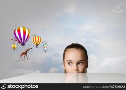 Giraffe flying on balloons. Little cute girl looking from under the table