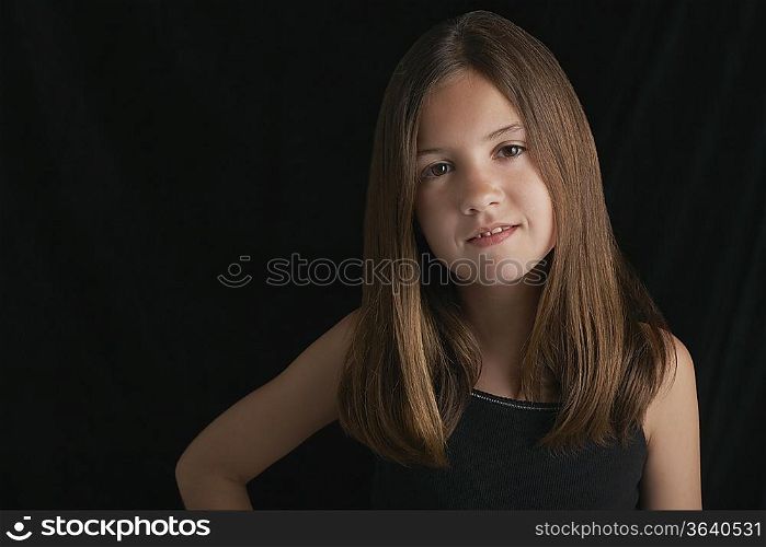 Girl (10-12) on black background portrait