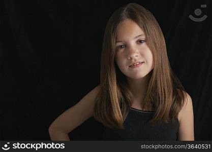Girl (10-12) on black background portrait