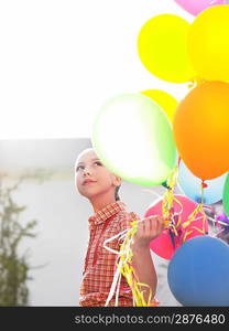 Girl (10-12) with bunch of balloons