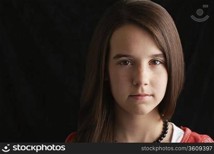 Girl (13-15) on black background portrait