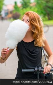 Girl 30 years walking in the park and eat cotton candy