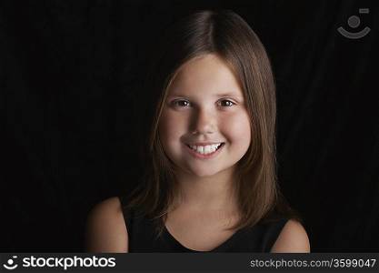 Girl (5-6) on black background portrait