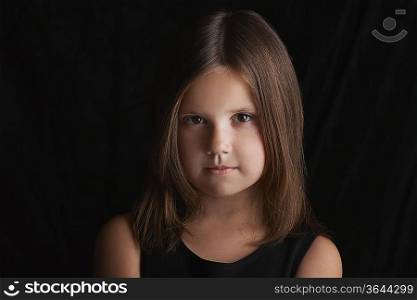 Girl (5-6) on black background portrait