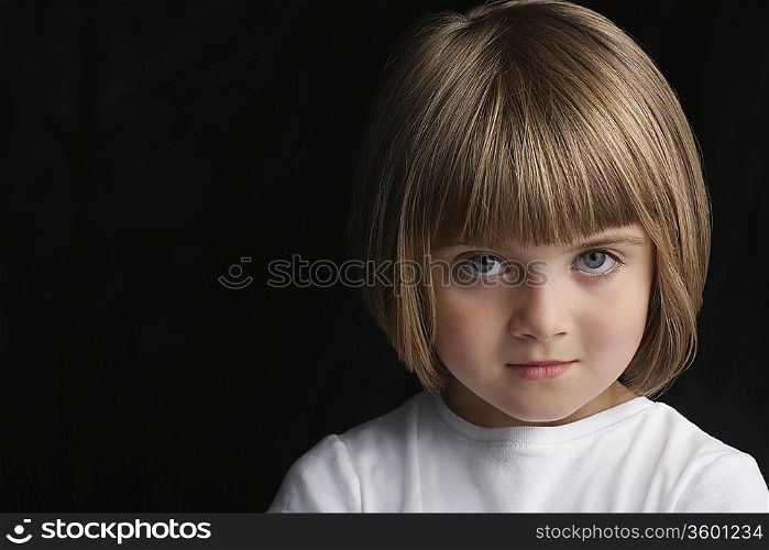 Girl (5-6) on black background portrait close-up