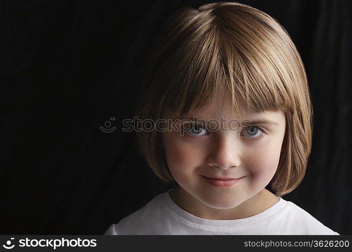 Girl (5-6) on black background portrait close-up