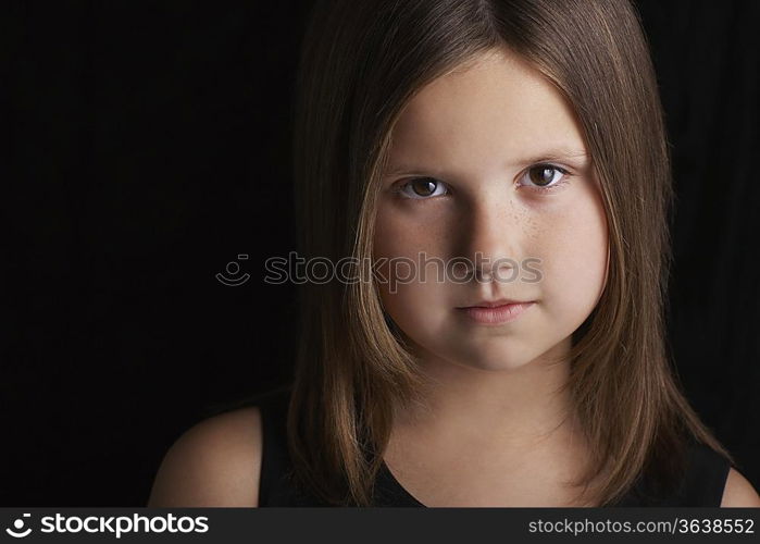 Girl (5-6) on black background portrait close up