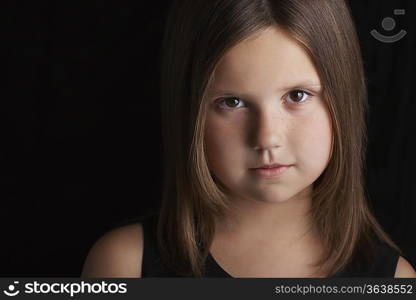 Girl (5-6) on black background portrait close up