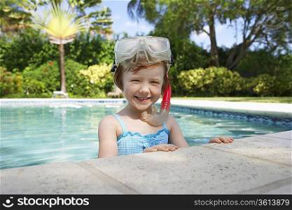 Girl (5-6) snorkelling in swimming pool, portrait