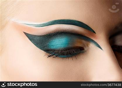 girl&acute;s eye closeup with creative green makeup, it&acute;s closed