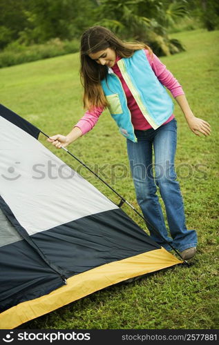 Girl adjusting a tent