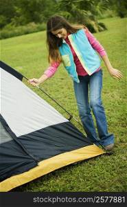 Girl adjusting a tent