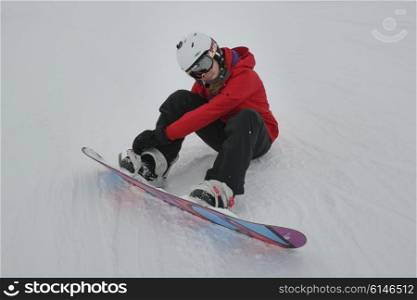 Girl adjusting snowboard, Whistler Blackcomb, Vancouver, British Columbia, Canada