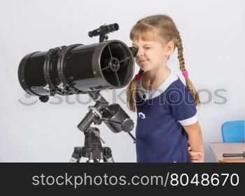 Girl amateur astronomer watching the stars through a telescope