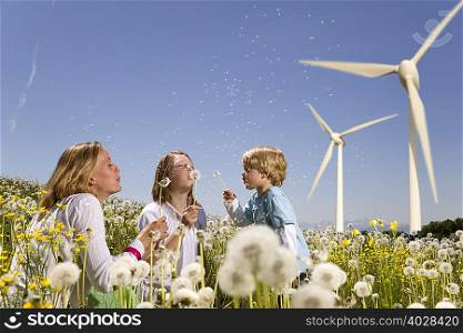 Girl and boy and mother at wind turbines