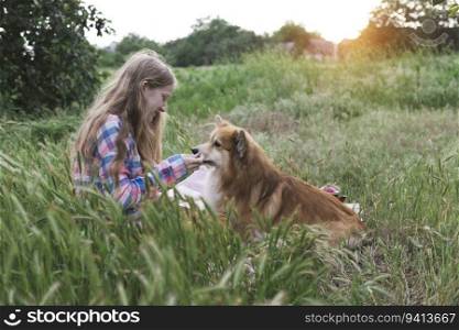 girl and corgi dog in the garden
